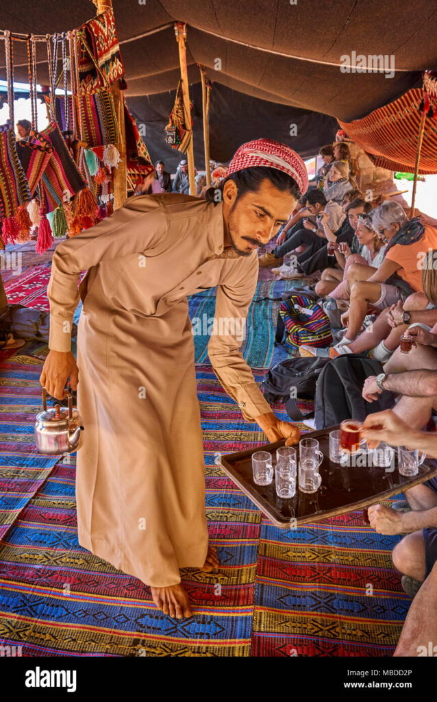 young-bedouin-serving-tea-to-the-tourists-wadi-rum-desert-jordan-MBDD2P